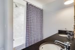 En-suite bath with double sinks off full size bedroom